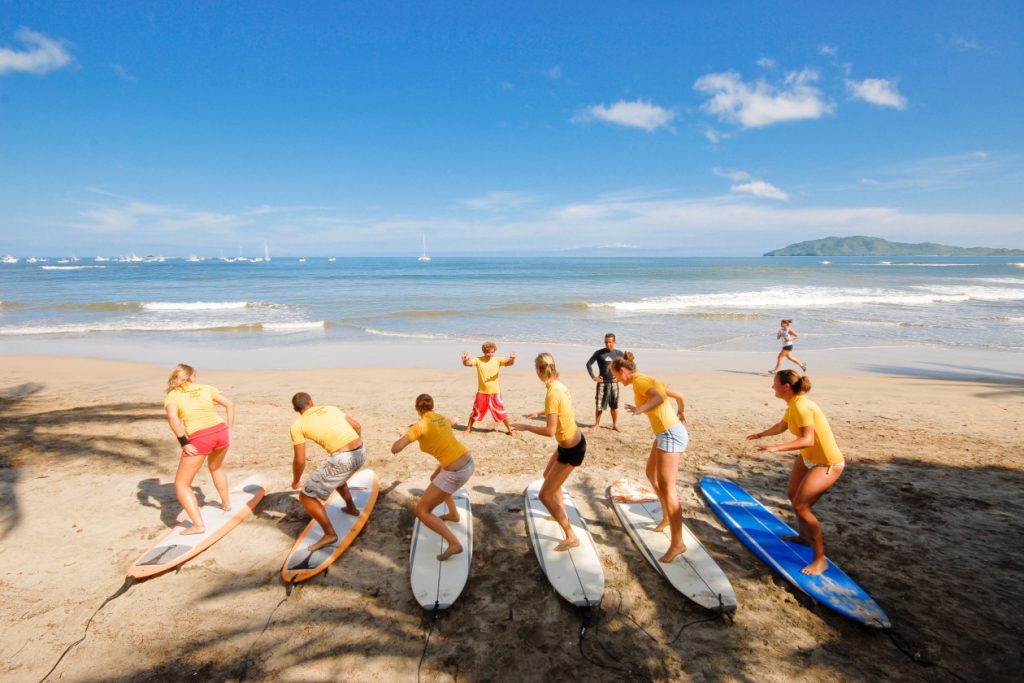 young surfers practicing their techniques at the beach in Costa Rica