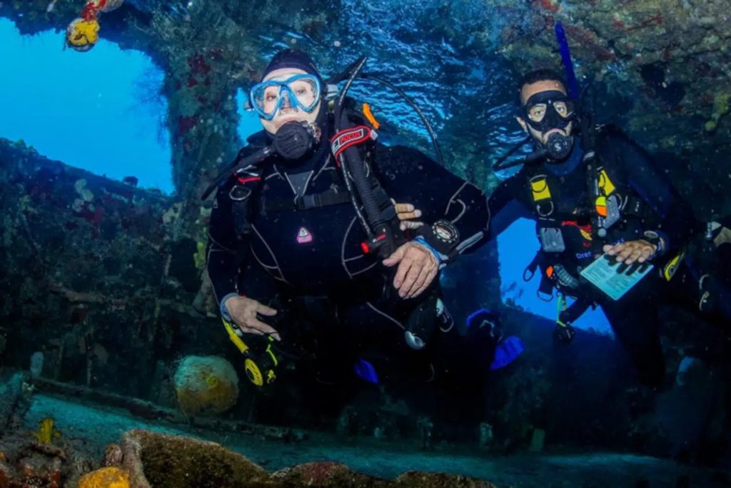 two divers exploring a shipwreck